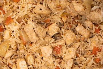 Tasty pilaf with chicken as background.