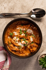 Flat Lay Bowl of Butter Chicken and Rice on a Marble Table