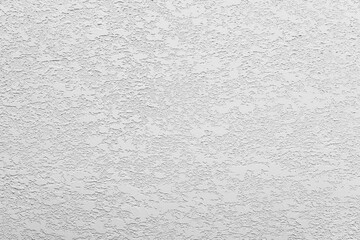 White-gray uniform background of decorative multilayer plaster on the wall, grunge background.