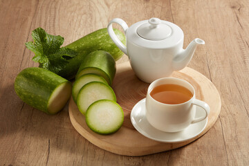 A tea set in white color decorated with some winter melon slices. Winter melon (Benincasa hispida)...