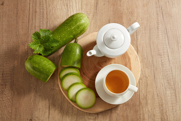 Flat lay of the cutting board featured a white tea set with fresh winter melon. Winter melon (Benincasa hispida) very effective in the treatment of many diseases