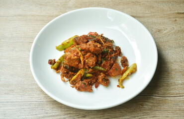 spicy slice stingray fish with eggplant and basil leaf in curry sauce on plate 