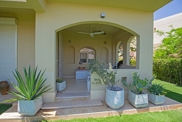 Exterior of luxury villa in tropical resort with patio area