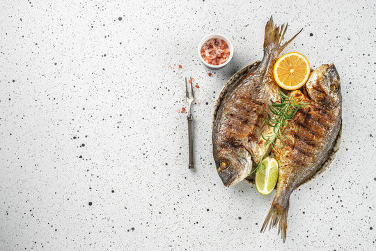 grilled whole fish dorado on a light background. Concept healthy and balanced eating. place for text, top view