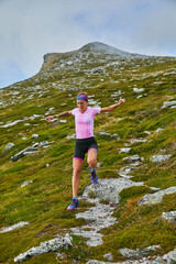 Female mountain runner running on a mountain