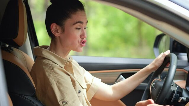 Brunette woman mad at offending driver clipping modern car on busy roadway. Businesswoman yells at unknown person and tries to signal on road