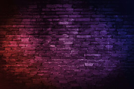 Neon light on brick walls that are not plastered background and texture. Lighting effect red and blue neon background of empty brick basement wall.