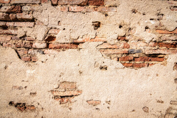 Old shabby white concrete and brick wall cracks. Cracked white cement wall. Old masonry stone bricks.