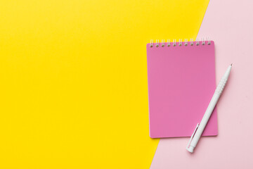 two school colored notebook on a desk background, spiral craft notepad on a table Top view