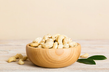 cashew nuts in wooden bowl on table background. top view. Space for text Healthy food