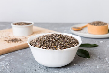 Chia seeds in bowl and spoon on colored background. Healthy Salvia hispanica in small bowl. Healthy superfood