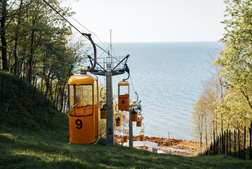 Yellow tourist passenger funicular on a hill near the sea shore