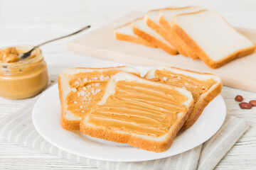 Peanut butter sandwiches or toasts on light table background.Breakfast. Vegetarian food. American cuisine top view vith copy space