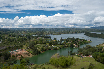 Fototapeta na wymiar Aerial panoramic view of the hydroelectric reservoir, lakes, mountains and many small islands of Guatape, near Medellin, Colombia. Sunny day, blue sky.