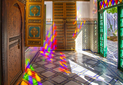 Marrakesh, Morocco - 5th February 2020: Beautiful interior of Bahia palace with antique doors and shutters with colorful light reflection 