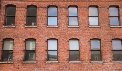 A vibrant business hub - the towering brick buildings radiate professionalism and success, embodying the strength and stability of corporate enterprises