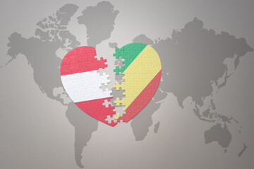 puzzle heart with the national flag of republic of the congo and austria on a world map background.Concept.