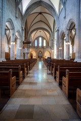 Reformed European church interior with empty wooden pews. Ultra wide angle view, no people
