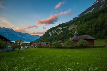 Fototapeta na wymiar Beautiful sunset in famous small tourist village Iseltwald, Switzerland. No people