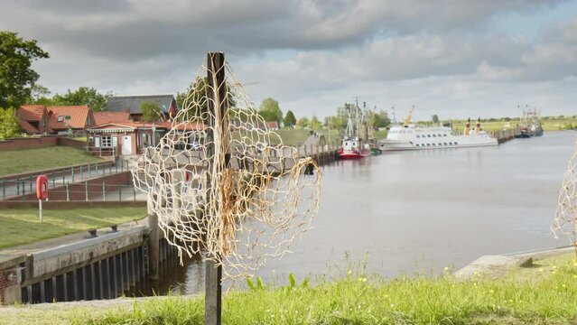Black Cross with a fishing net in the Harbor of Greetsiel as a silent protest by the fishermen against a planned ban of bottom trawls