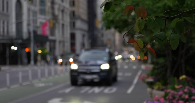 An evening slow motion view of traffic on Manhattan's 5th Avenue near Madison Square Park.  	