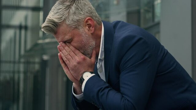 Caucasian sad upset business man senior mature stressed ill depressed businessman middle-aged gray haired hopeless despair employer in city suffering headache failure problem unemployment grief stress