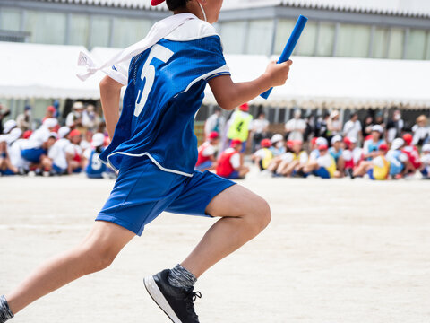 小学校の運動会でリレーを走る子供