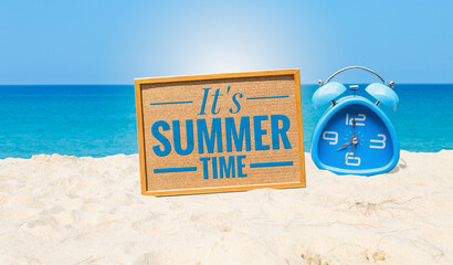 It's summer time sign with alarm clock on the beach, summer outdoor day light
