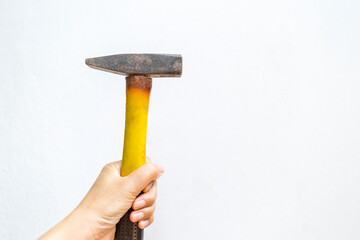 Old hammer in girl hand with space on white background, rusty tool, dangerous damaged tool, construction equipment