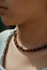 Amber beads close-up on the girl's neck