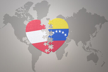 puzzle heart with the national flag of venezuela and austria on a world map background.Concept.
