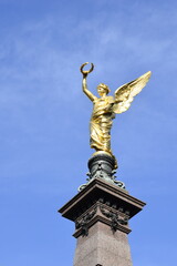 Fototapeta premium Golden angel statue on the monument for Johann Andreas von Liebenberg, Mayor of Vienna during the Second Siege of Vienna by the Turks in 1683. Monument inaugurated in 1890. It is in Vienna, Austria.
