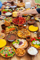 Homemade Romanian Food with grilled meat, polenta and vegetables Platter on camping. Romantic traditional moldavian food outside on the wood table.