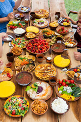 Homemade Romanian Food with grilled meat, polenta and vegetables Platter on camping. Romantic traditional moldavian food outside on the wood table.