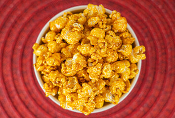 Bowl with delicious caramel popcorn. Homemade Fresh Popped Caramel PopCorn. Sweet caramel flavoured popcorn in bowl.