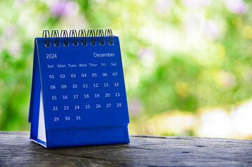December 2024 blue table calendar with customizable space for text. Calendar concept and copy space.