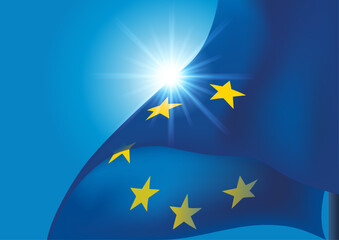 Drapeau de Union Européenne flottant à contre-jour sur un fond de ciel bleu.