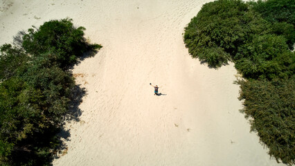 drone view of one person in the middle of a dune in Patara beach, Turkey.