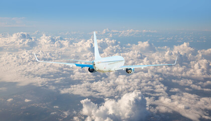 White passenger airplane flying in the sky amazing clouds in the background - Travel by air...