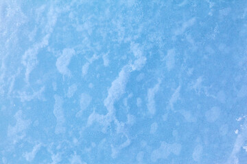 Texture of winter ice surface. Blue natural ice background