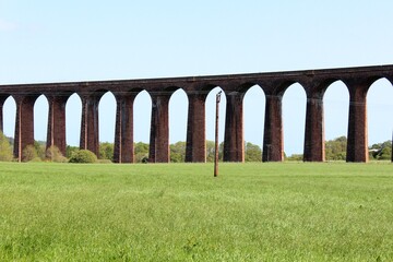 A closeup view of the clava nairn viaduct or the impressive 29 arches of the Culloden viaduct that stretch over the valley and River Nairn, an Inverness, Scotland architectural sight to see. - obrazy, fototapety, plakaty