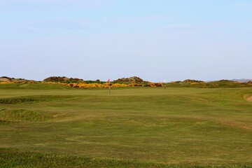 An incredible view of the most famous and historic classic links golf course, full of pot bunkers and rolling fairways, the Old Course in St. Andrews, Scotland 