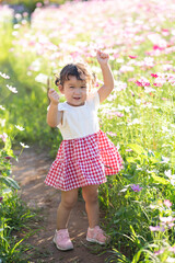 portrait of a little girl in flower garden
