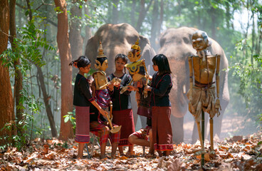 Group of Asian boys and girl enjoy to show or practice manipulate the puppets in  front of big...