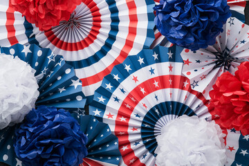 4th of July background. USA paper fans, Red, blue, white stars, balloons, gold confetti on gray...
