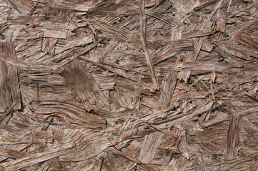 brown chipboard closeup.wooden detailed background with sawdust and shavings. Seamless compressed...