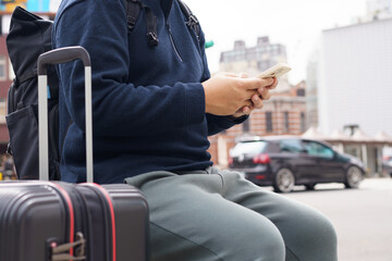 Man in downtown city street ordering taxi using smart phone app Booking taxi using application online on smart phone