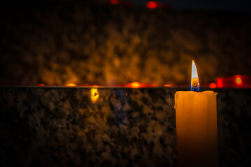 burning candle on black background