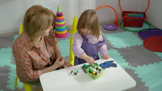 Playful Discoveries Child Engages in Developmental Games with Teacher Kindergarten Fun. High quality 4k footage