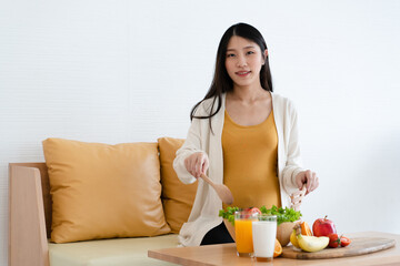 Asian mothers pregnant are about to eat healthy foods such as fruits, vegetables and milk....